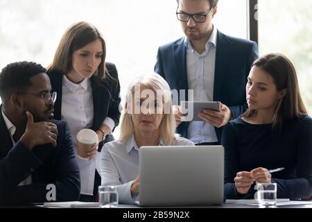 Diverse businesspeople brainstorm work together at laptop Stock Photo