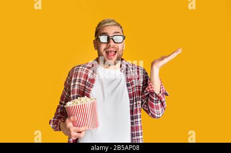 Funny man in glasses and popcorn ready to watch movie Stock Photo