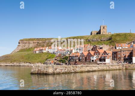 The view across the River Esk in the town of Whitby in North Yorkshire, England.  St Mary's Church overlooks the town from the top of the east cliff. Stock Photo