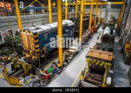 A British Rail Class 08 diesel-electric shunting locomotive in the workshop at the National Railway Museum, York, England. Stock Photo