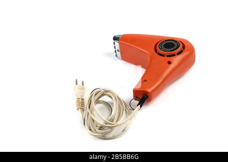 Vintage orange hair dryer on white background with rolled cable buttom. Stock Photo