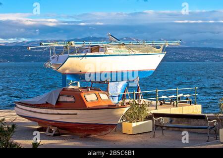 Sailboat and small boat on dry dock by the sea, Opatija, Croatia Stock Photo