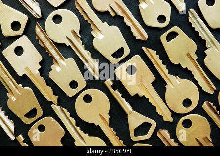 Lot of different yellow keys on dark background. Different opportunities and choices concept. Stock Photo