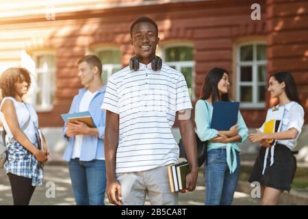 Education grants. Portrait of happy african student posing in university campus Stock Photo