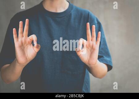 Woman standing and positive hand sign approving conceptual. Stock Photo