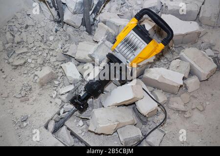 pieces of broken wall next to the jackhammer Stock Photo