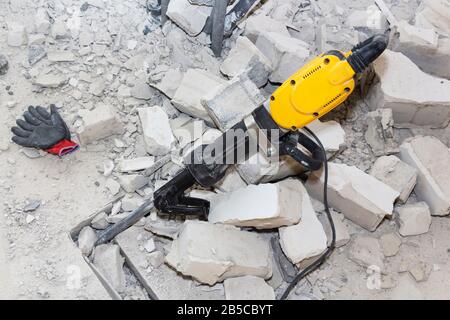 pieces of broken wall next to the jackhammer Stock Photo