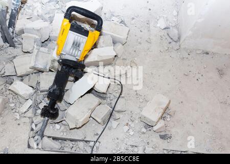 pieces of broken wall next to the jackhammer Stock Photo