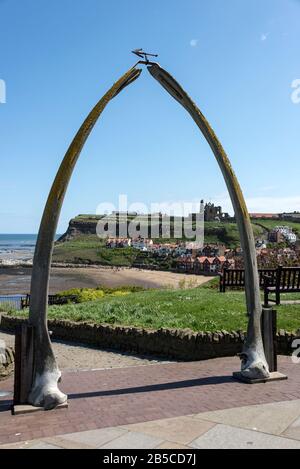 One of Whitby's  landmarks above West Cliff, is a Whalebone Arch towards St. Mary's Church on a hill above the historic town in Whitby, North Yorkshir Stock Photo