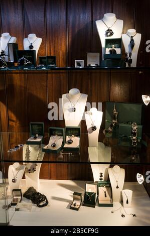 A large window display of handcrafted Whitby organic gemstone jet black rings and necklaces at W.Hamond the famous original Whitby Black Jet jeweller Stock Photo