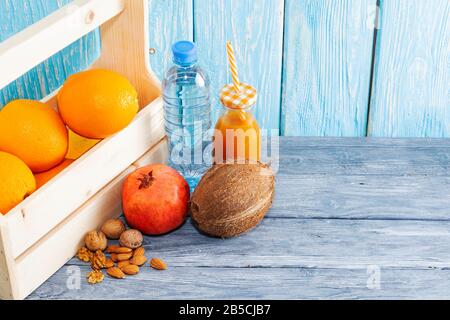 Healthy food, nutrition concept and vegetarian diet, fresh juice, orange, almonds, walnuts. Close-up wooden background Stock Photo