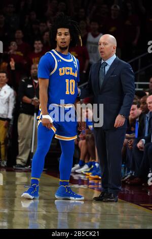 UCLA Bruins head coach Mick Cronin (right) talks with guard Tyger Campbell (10) during an NCAA college basketball game against the Southern California Trojans, Saturday, March 7, 2020, in Los Angeles. USC defeated UCLA 54-52. (Photo by IOS/ESPA-Images) Stock Photo