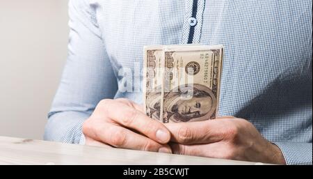 Businessman counts usd dollar money in hands. Stock Photo