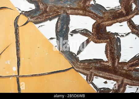 Abstract corroded old paint on metal wall. Cracked white beige yellow metal rust texture background Stock Photo