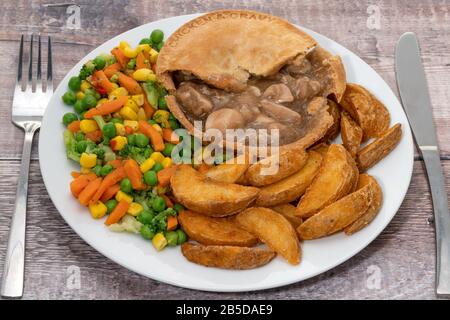 Chicken pie with vegetables and potato fries with gravy Stock Photo