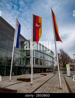 Hameln, Germany. 08th Mar, 2020. Flags are waving in front of the district house as the seat of the district administrator in Hameln. Four men are running. The previous district administrator had resigned after hostilities in social networks and the abuse case of Lügde. Should none of the candidates achieve an absolute majority in the first round of voting, there will be a run-off vote on 22 March. Credit: Peter Steffen/dpa/Alamy Live News Stock Photo