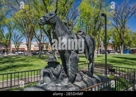 Cowboy at Rest bronze statue, 1990, based on smaller version created by Solon Hannibal Borglum in 1904, at Courthouse Plaza in Prescott, Arizona, USA Stock Photo