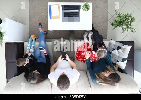 Modern Family Using Gadgets at Breakfast in Cozy Kitchen Stock