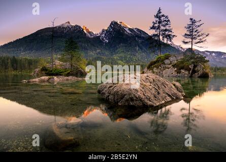 View on turquoise water and scene of trees on a rock island at Lake Hintersee. Location famous resort National park Berchtesgadener Land, Ramsau, Bava Stock Photo
