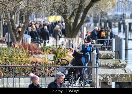 08 March 2020, Baden-Wuerttemberg, Überlingen: Walkers walk along the Bodensee promenade. Photo: Felix Kästle/dpa Stock Photo