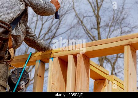 Contractor framing up wall section for a framing building custom house Stock Photo