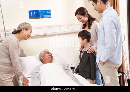 asian family with child visiting grandparents in hospital Stock Photo