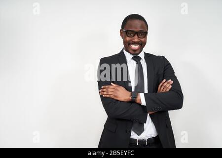 African american businessman standing over white background happy face smiling with crossed arms looking at the camera. Positive person. Stock Photo