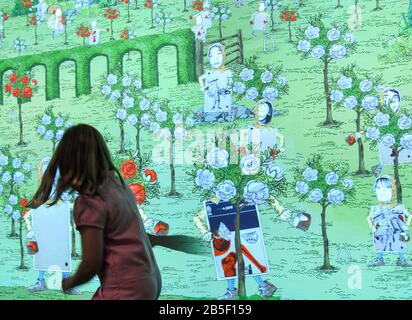 Wellington, New Zealand. 8th Mar, 2020. A child interacts with cartoon animation on the wall at exhibition 'Wonderland' in the Te Papa National Museum in Wellington, New Zealand, March 8, 2020. The three-month exhibition 'Wonderland' ended on Sunday, which displayed more than 300 objects and props related to the famous British literature 'Alice in Wonderland'. Credit: Guo Lei/Xinhua/Alamy Live News Stock Photo