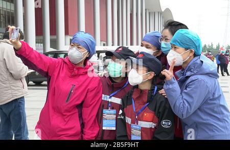 (200308) -- WUHAN, March 8, 2020 (Xinhua) -- Medical workers of the 'Wuhan Livingroom' makeshift hospital take a selfie in Wuhan, central China's Hubei Province, March 8, 2020. The 'Wuhan Livingroom' makeshift hospital officially closed on Sunday. (Xinhua/Rao Liwen) Stock Photo