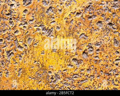 Many rugged holes on the rusty color concrete floor Stock Photo