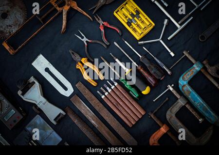 Photo top view a huge set collection of working hand and power tools many for the wooden on isolated black background, Toolset with interior,  do-it-y Stock Photo