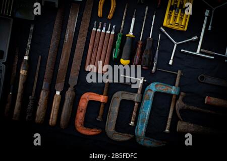 Photo top view a huge set collection of working hand and power tools many for the wooden on isolated black background, Old toolset with interior,  do- Stock Photo