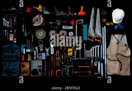 Photo top view a huge set collection of working hand and power tools many for the wooden on isolated black background, Old toolset with interior,  do- Stock Photo