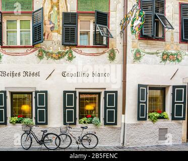 Facade of the building of the famous restaurant 'Cavallino Bianco' in the historic center of Bolzano in South Tyrol, Trentino Alto Adige, Italy Stock Photo