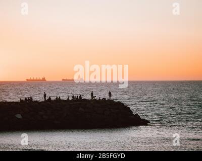 Silhouette of a Pier on the coast at sunset in Australia Stock Photo