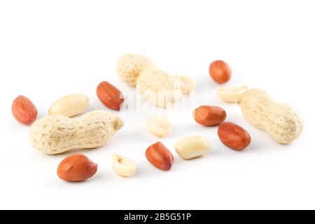 Peeled peanut and beans in shell isolated on white background. Ground beans Stock Photo