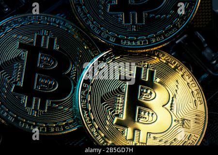 Golden Bitcoin Cryptocurrency on a computer board. Macro shooting. The concept of cryptocurrency with coins, bitcoin on a computer processor. New cryp Stock Photo