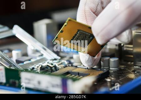 Electronic engineer of computer technology. Maintenance computer cpu hardware upgrade of motherboard component. Pc repair, technician and industry sup Stock Photo