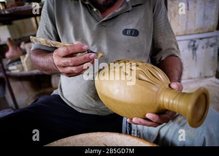Closeup of local craftsman demonstrates on making traditional clay jar called Labu Sayong or Essence Jar of Sayong at Kuala Kangsar, Perak, Malaysia. Stock Photo