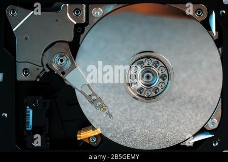 Disassembled hard drive from the computer, hdd with mirror effect Opened hard drive from the computer hdd with mirror effects Part of computer pc, lap Stock Photo