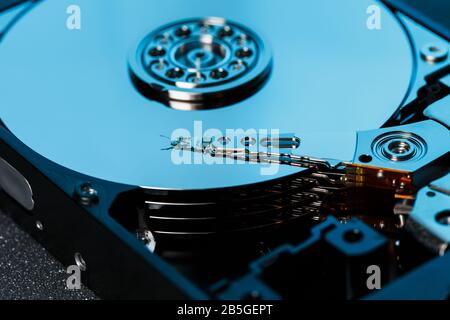 Disassembled hard drive from the computer, hdd with mirror effect. Opened hard drive from the computer hdd with mirror effects. Part of computer pc, l Stock Photo
