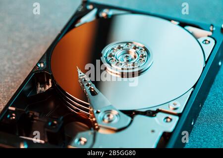 Disassembled hard drive from the computer, hdd with mirror effect. Opened hard drive from the computer hdd with mirror effects. Part of computer pc, l Stock Photo