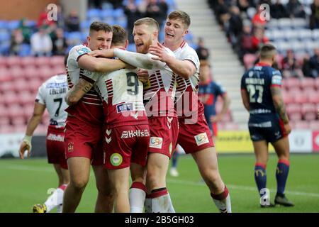 Wigan warriors Sam Powell is mobbed after he scores during the Betfred Super League match at DW Stadium, Wigan. Stock Photo