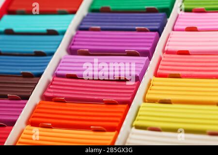 Plasticine in a box of multi-colored pieces in full screen, material for modeling. Texture, background. Stock Photo