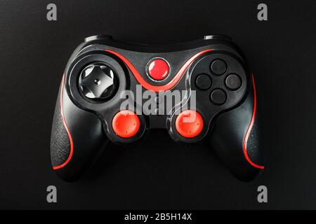 Black Game controller gamepad on black background close Up . Device to control and control the game. Video games on PC, console, smartphone. Stock Photo