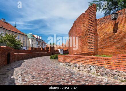 Cobblestone alley along city walls of Warsaw Old Town in Poland Stock Photo