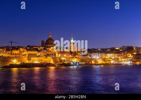 Sea view of Valletta city at night in Malta Stock Photo