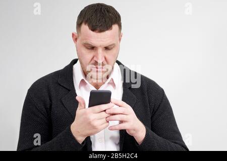 Portrait of businessman using smartphone over gray background Stock Photo