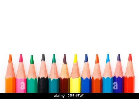 Colored pencils in a row on a white background, free space for text. Isolate Stock Photo