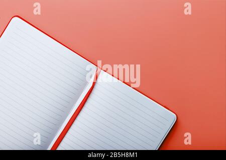 Open notebook, a book with blank and blank pages on a pink background, top view. Layout for design, free space Stock Photo